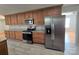 Modern kitchen with stainless steel appliances and wood cabinets at 433 Pamela St, Gastonia, NC 28054