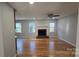 Cozy living room with a brick fireplace, hardwood floors, and plenty of natural light at 433 Pamela St, Gastonia, NC 28054