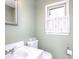 Clean bathroom with sink, toilet, and window with shutters at 5315 Ruth Dr, Charlotte, NC 28215