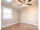 Spacious bedroom with hardwood floors and ceiling fan at 5315 Ruth Dr, Charlotte, NC 28215