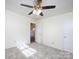 Bedroom with ceiling fan and access to hallway at 5315 Ruth Dr, Charlotte, NC 28215