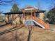 Brick ranch house with a wooden deck and stairs at 5315 Ruth Dr, Charlotte, NC 28215