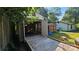 Open garage with vintage car and ramp, featuring additional storage shed and backyard space at 5315 Ruth Dr, Charlotte, NC 28215