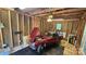 Partially renovated garage with a vintage car parked inside, featuring ceiling fan at 5315 Ruth Dr, Charlotte, NC 28215