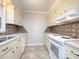 Kitchen with white cabinets and patterned backsplash at 5315 Ruth Dr, Charlotte, NC 28215