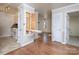 Open concept kitchen and living area with hardwood floors and built-in ironing board at 5315 Ruth Dr, Charlotte, NC 28215