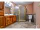 Bathroom features wood cabinets and a corner shower at 5839 Painted Fern Ct, Charlotte, NC 28269