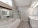 Primary bathroom with soaking tub, double vanity, and a walk-in shower at 5839 Painted Fern Ct, Charlotte, NC 28269