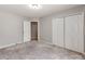 Bright bedroom with neutral walls, carpet, and double door closet at 5839 Painted Fern Ct, Charlotte, NC 28269