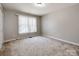 Spacious bedroom featuring a window with blinds and neutral decor at 5839 Painted Fern Ct, Charlotte, NC 28269