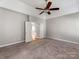 Bright bedroom with ceiling fan and access to another room at 5839 Painted Fern Ct, Charlotte, NC 28269