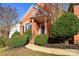 Front entry of a brick house with bushes and a walkway at 5839 Painted Fern Ct, Charlotte, NC 28269