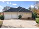 Rear view of house showcasing two-car garage and landscaping at 5839 Painted Fern Ct, Charlotte, NC 28269