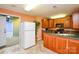Kitchenette with wood cabinets and a large refrigerator at 5839 Painted Fern Ct, Charlotte, NC 28269