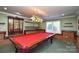 Basement recreation room with pool table and brick wall at 5839 Painted Fern Ct, Charlotte, NC 28269