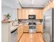 Kitchen with wood cabinets, stainless steel appliances, and granite countertops at 721 Governor Morrison St # 425, Charlotte, NC 28211