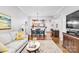 Open-concept living and dining area with a kitchen view, featuring hardwood floors and a comfortable seating arrangement at 721 Governor Morrison St # 425, Charlotte, NC 28211