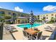 Exterior view of community pool and seating area featuring lounge chairs and shade umbrellas at 721 Governor Morrison St # 425, Charlotte, NC 28211