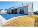 Expansive fenced backyard with covered patio and lush, golden grass at 7669 Tanglewood Way, Denver, NC 28037