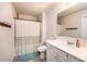Bathroom with shower and tub combination, white sink, and tiled floors at 7669 Tanglewood Way, Denver, NC 28037