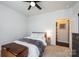 Cozy bedroom features a ceiling fan, a comfortable bed, and carpet floors at 7669 Tanglewood Way, Denver, NC 28037
