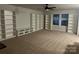 Spacious carpeted bonus room with bright white built-in shelves and ample storage at 7669 Tanglewood Way, Denver, NC 28037