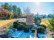 Landscaped neighborhood entrance sign with stone pillar and lush shrubbery at 7669 Tanglewood Way, Denver, NC 28037