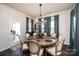 Dining room with round table, seating for eight, and access to outdoor patio at 7669 Tanglewood Way, Denver, NC 28037