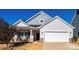 Charming home featuring a two-car garage, inviting front porch, and well-maintained landscaping at 7669 Tanglewood Way, Denver, NC 28037