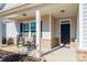 Cozy covered porch with rocking chairs, creating a welcoming entry to the home at 7669 Tanglewood Way, Denver, NC 28037