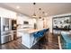 Kitchen featuring modern appliances, countertop seating, and a stainless refrigerator at 7669 Tanglewood Way, Denver, NC 28037