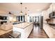 Open concept kitchen with large island, white cabinets, stainless appliances, and view of the living room at 7669 Tanglewood Way, Denver, NC 28037