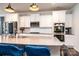 Bright kitchen with white cabinets, stainless steel appliances, and quartz countertops at 7669 Tanglewood Way, Denver, NC 28037