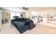 Spacious living room featuring a large gray couch, shelves of toys, and a desk space at 7669 Tanglewood Way, Denver, NC 28037