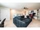 Spacious living room featuring a large couch, shelves of toys, and a desk space at 7669 Tanglewood Way, Denver, NC 28037