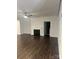 Bright and spacious living room features a modern fireplace, ceiling fan, and dark laminate flooring at 7669 Tanglewood Way, Denver, NC 28037