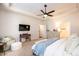 Spacious main bedroom featuring a tray ceiling, large windows, and comfortable seating area at 7669 Tanglewood Way, Denver, NC 28037