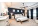 Relaxing main bedroom with a tray ceiling, dark accent wall, and cozy furnishings at 7669 Tanglewood Way, Denver, NC 28037