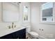 Clean bathroom with dark vanity and gold fixtures at 901 Edgemont Ave, Belmont, NC 28012