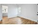 Neutral bedroom with light wood floors offers views into the ensuite bathroom at 901 Edgemont Ave, Belmont, NC 28012