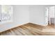 Bright bedroom with hardwood flooring, white walls, and natural light streaming through the large window at 901 Edgemont Ave, Belmont, NC 28012