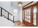 Bright foyer with wood floors, a modern staircase, and a glass-paneled front door at 901 Edgemont Ave, Belmont, NC 28012