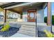 Close-up of the front porch featuring a wooden door with glass panels at 901 Edgemont Ave, Belmont, NC 28012