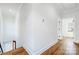 Hallway with wood floors, neutral walls, and natural light provides a bright, open transition at 901 Edgemont Ave, Belmont, NC 28012