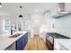 Open floor plan shows a kitchen with an island with stainless steel appliances and hardwood flooring at 901 Edgemont Ave, Belmont, NC 28012
