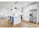 Modern kitchen with white cabinets, stainless steel appliances, and a center island at 901 Edgemont Ave, Belmont, NC 28012