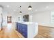 Bright, open floor plan includes a kitchen with a central island, stainless steel appliances, and hardwood floors at 901 Edgemont Ave, Belmont, NC 28012