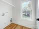 Bright laundry room featuring new floors and a window offering plenty of natural light at 901 Edgemont Ave, Belmont, NC 28012