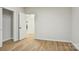 Bedroom with wood-look flooring, access to closet, and open doorway to another room at 1423 Roseland Dr, Lincolnton, NC 28092