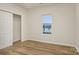 Bright bedroom features a window, closet, and modern wood-look laminate flooring at 1423 Roseland Dr, Lincolnton, NC 28092